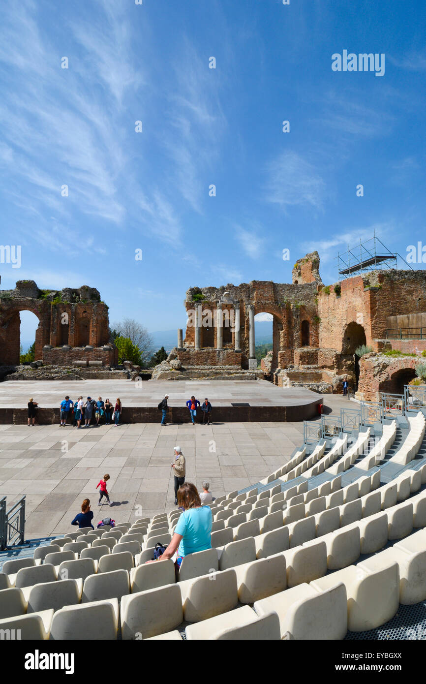 The Greek theatre or Teatro Greco in Taormina, Sicily with the snow capped Mount Etna in the background Stock Photo