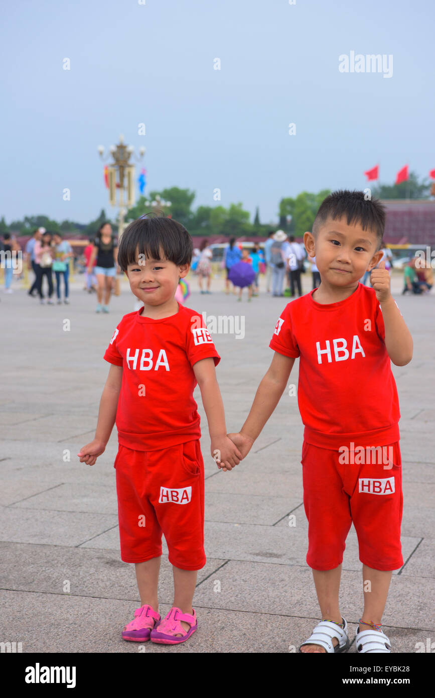 Chinese siblings in matching HBA-gear approve of a visit to Beijing's Tiananmen Square - July 2015 Stock Photo