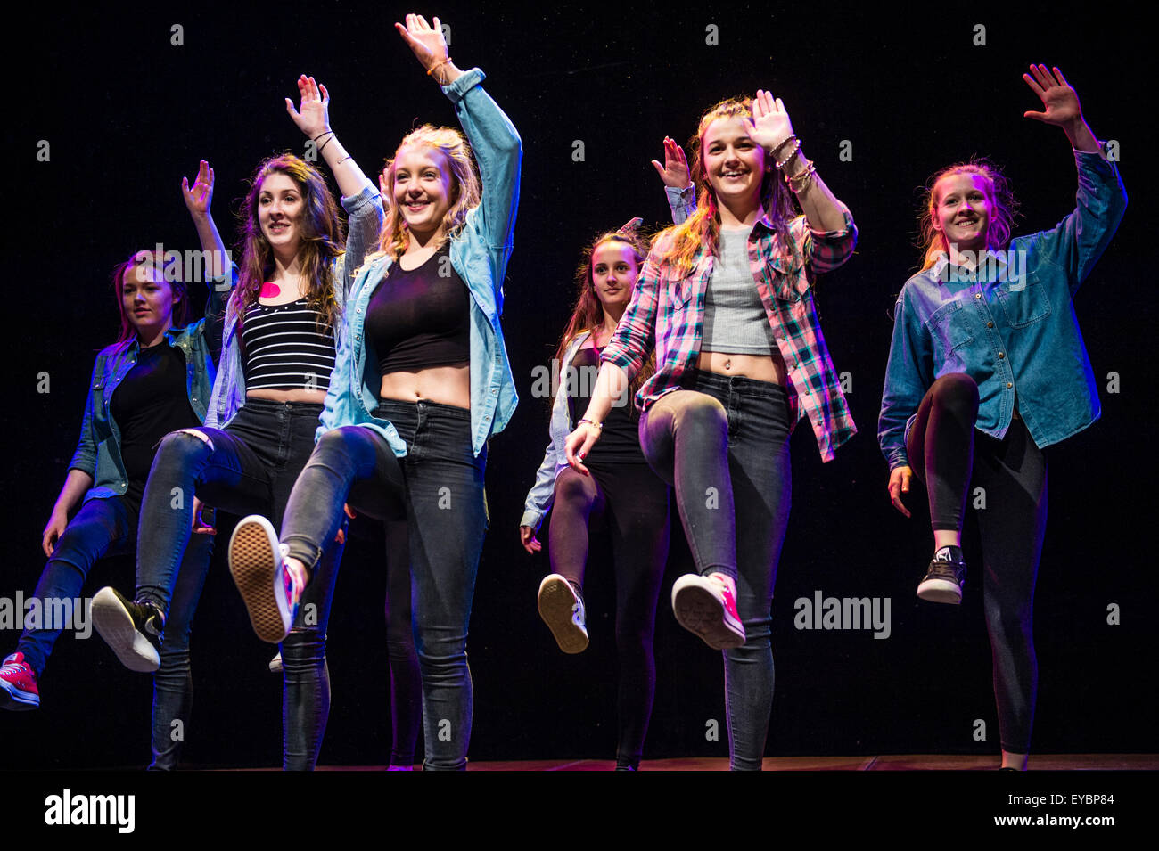 A group of teenage girls performing choreographed modern urban dance