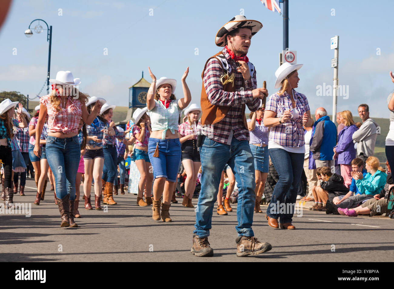 Swanage, Dorset UK 26 July 2015. Swanage Carnival Procession in July with the theme of Superheroes - cowgirl line dancer  Credit:  Carolyn Jenkins/Alamy Live News Stock Photo