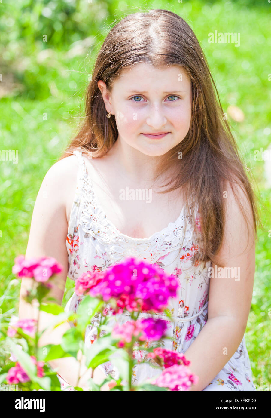 Portrait of a 10 year old girl enjoying the flower garden at home. Stock Photo