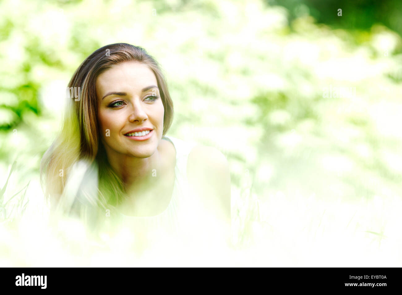 young woman in blue dress lying on grass Stock Photo - Alamy
