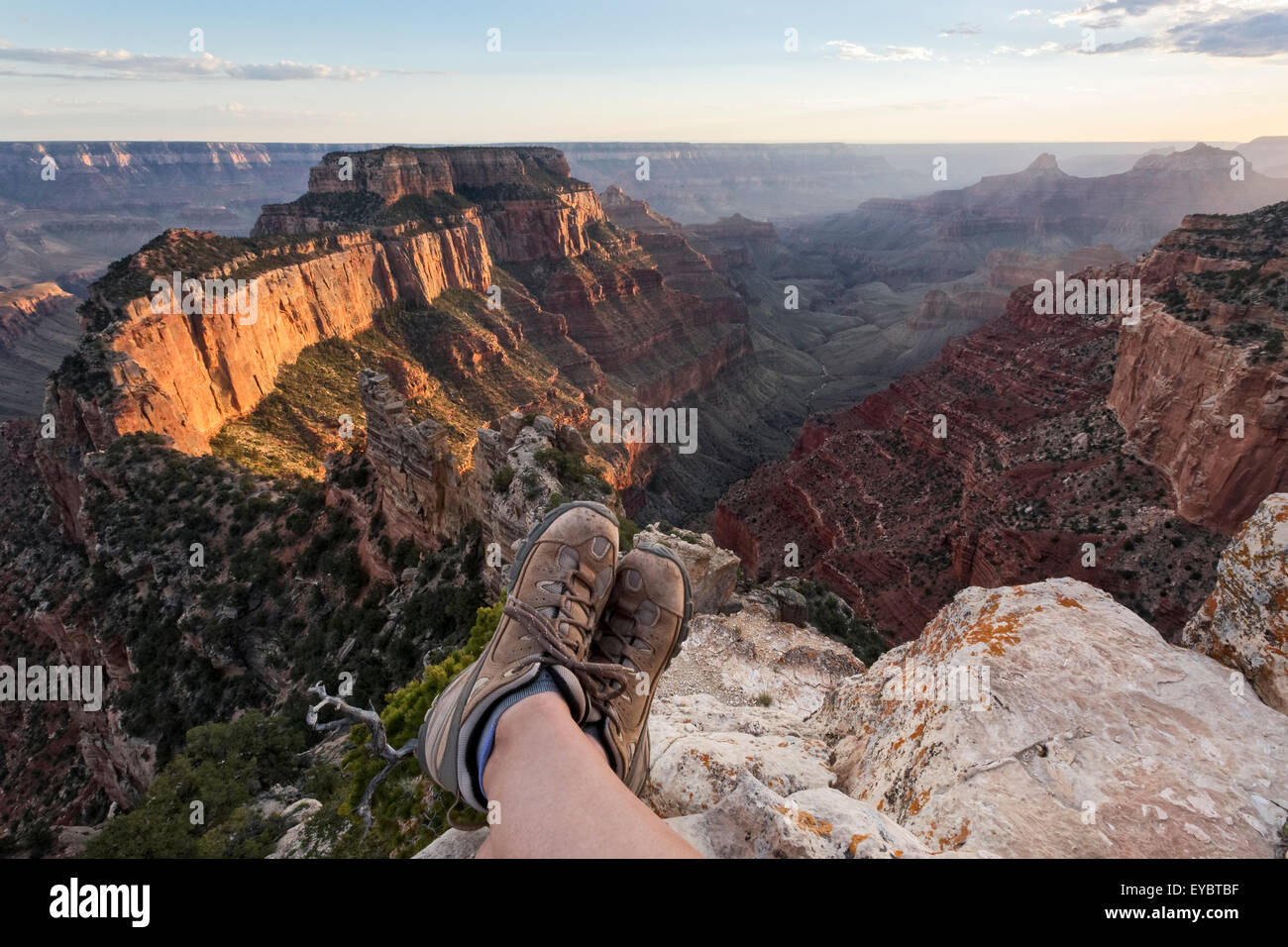Person sitting showing feet only with hiking boots on, Grand Canyon National Park, North Rim, Arizona Stock Photo