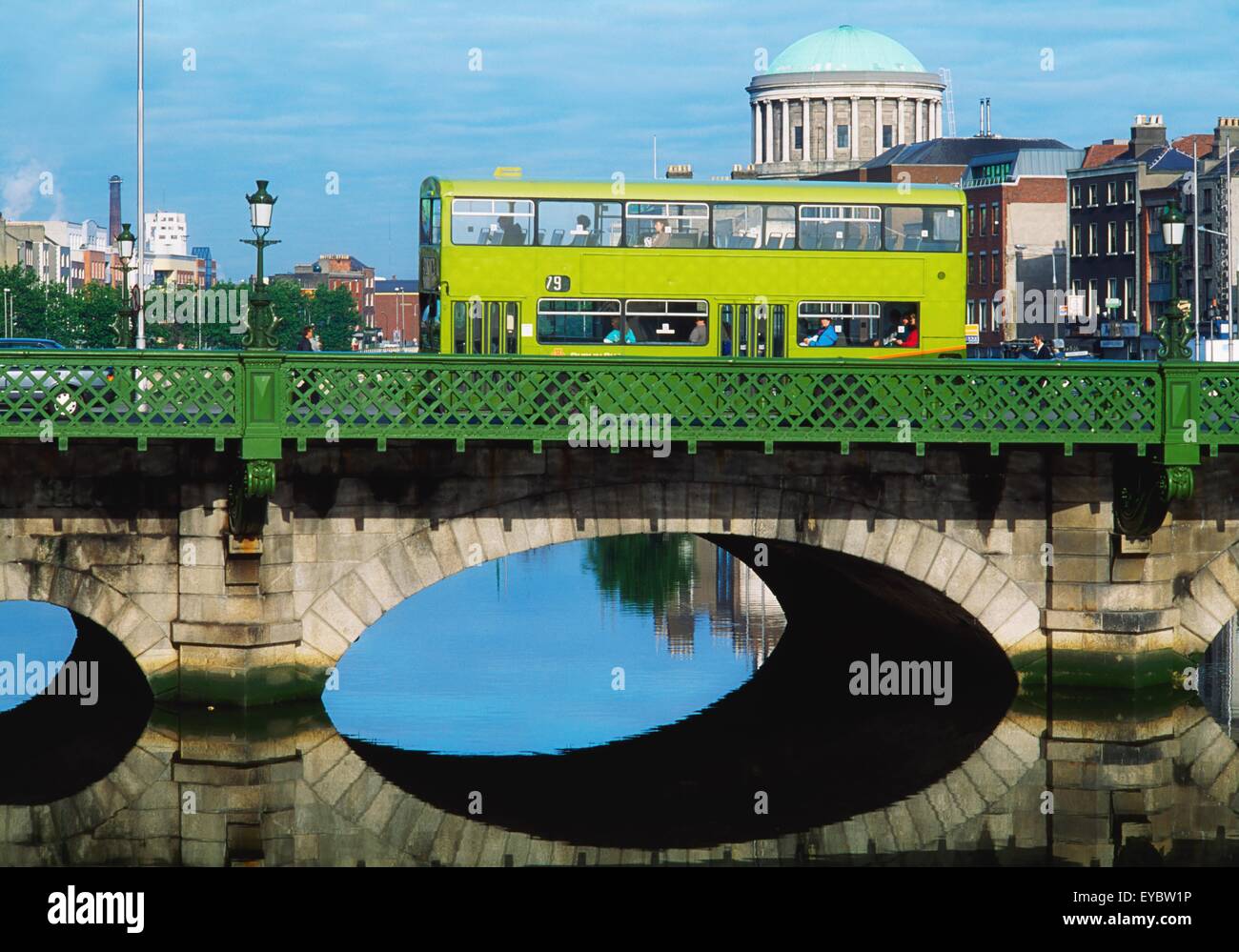 Dublin, Co Dublin, Ireland; Dublin Bus Going Over The Capel St. Bridge With Four Courts In The Background Stock Photo