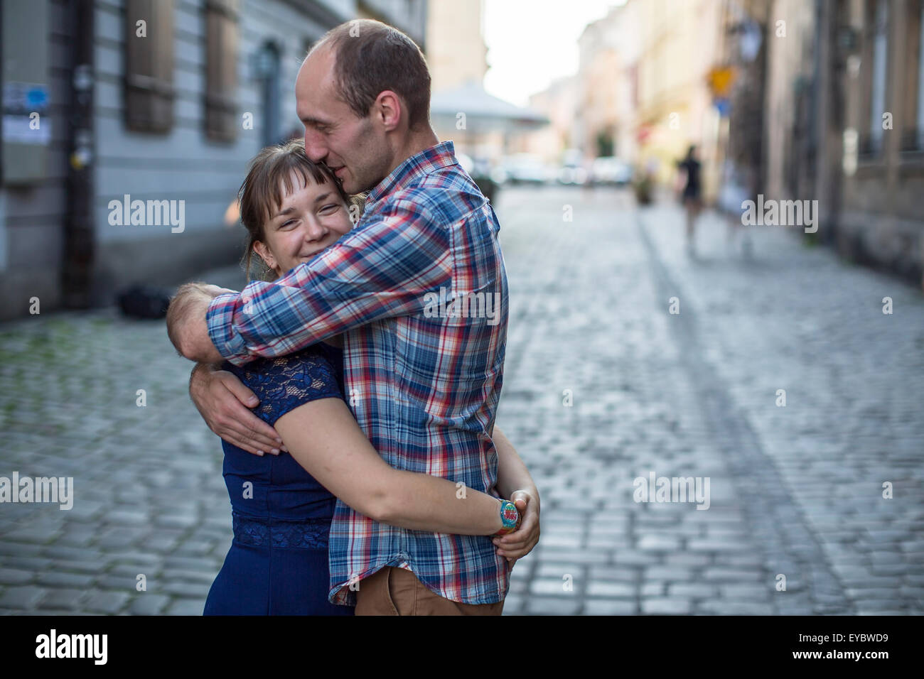 Couple in love hugging on the street. Man and woman during honeymoon ...