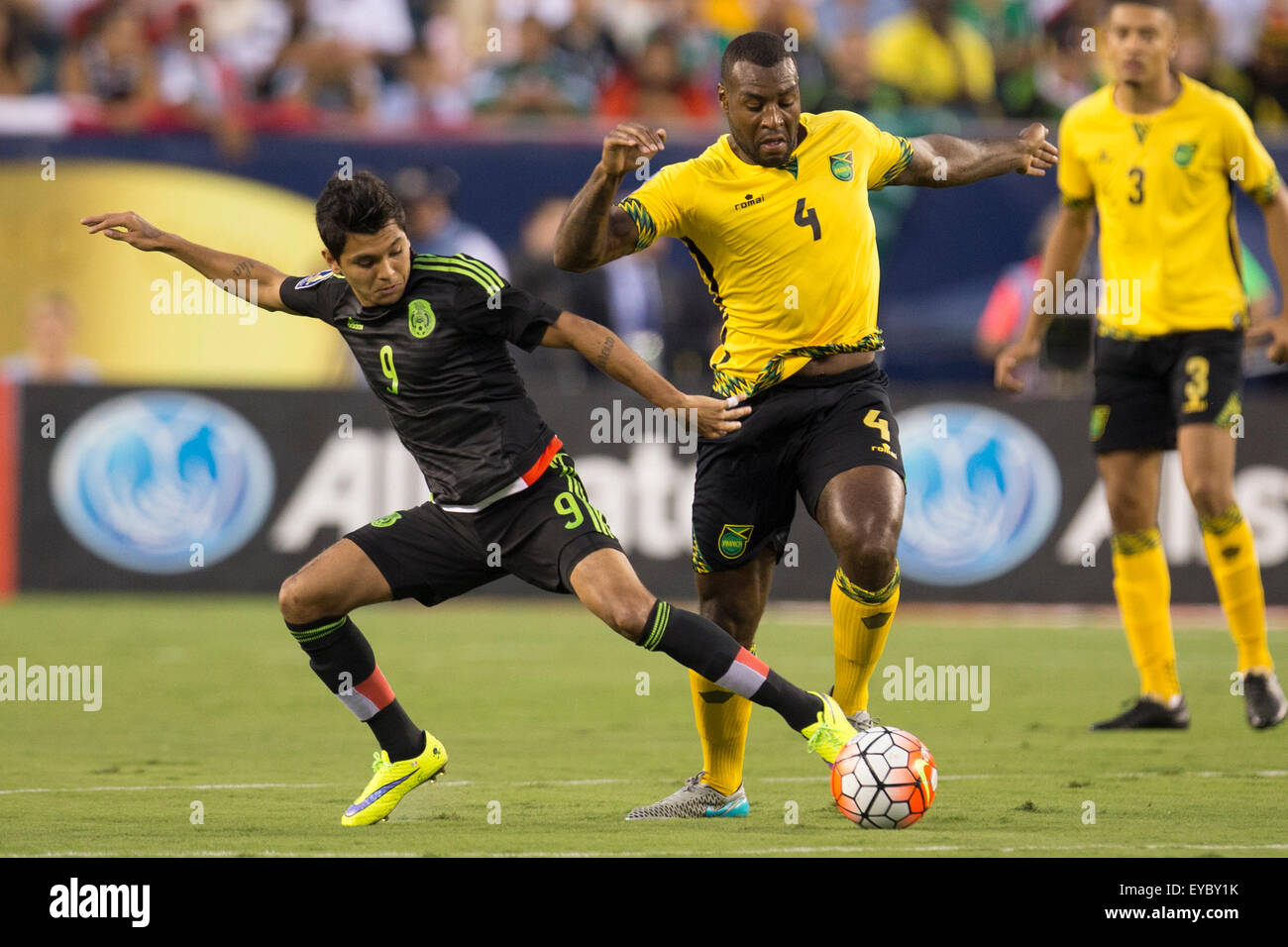 Philadelphia, Pennsylvania, USA. 26th July, 2015. Mexico forward Jesus Corona (9) battles with Jamaica defender Wes Morgan (4) for the ball during the CONCACAF Gold Cup 2015 Final match between Jamaica and Mexico at Lincoln Financial Field in Philadelphia, Pennsylvania. Christopher Szagola/CSM/Alamy Live News Stock Photo