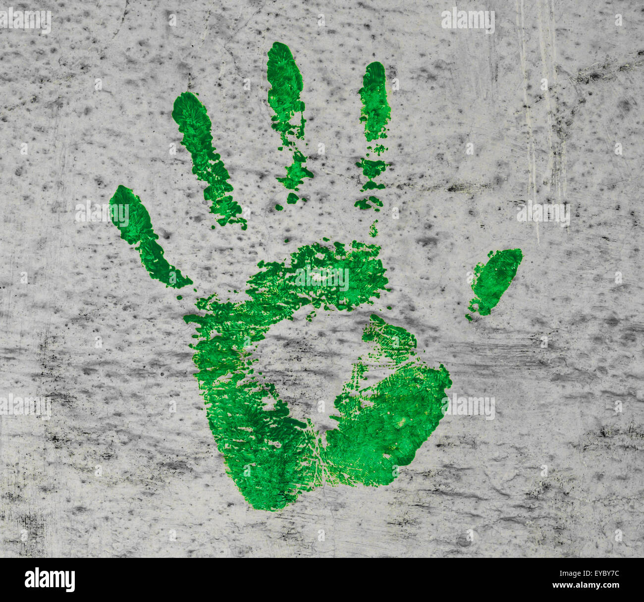 Green painted hand print on a grunge wall Stock Photo