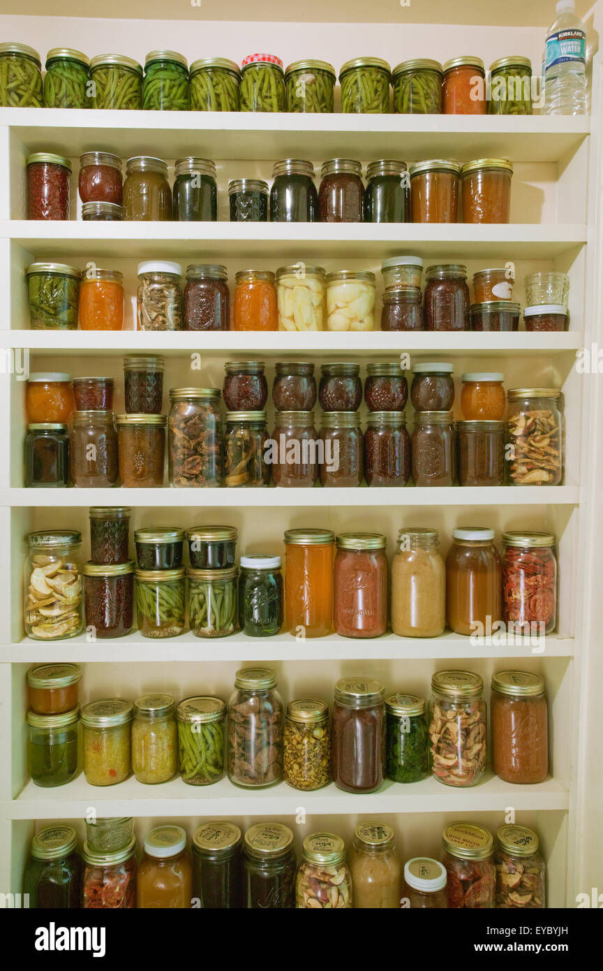 Pantry Of Preserved Fruits And Vegetables In Canning Jars In Stock