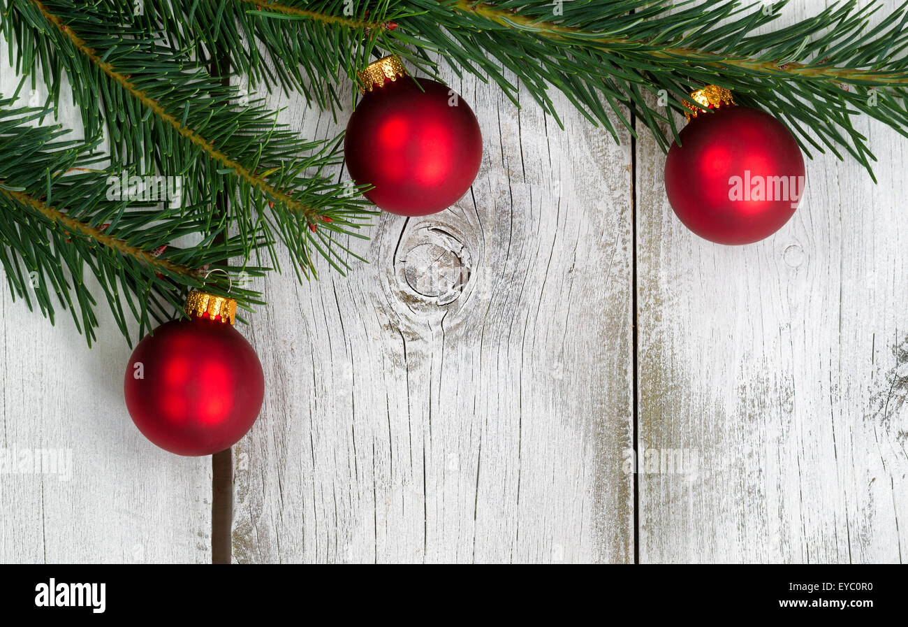 Real Grand Fir tree branch with three red ornaments on rustic white ...