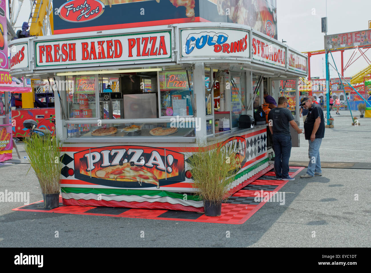 Two men talking outside a food stand at the Delaware State Fair in Harrington, DE. Stock Photo