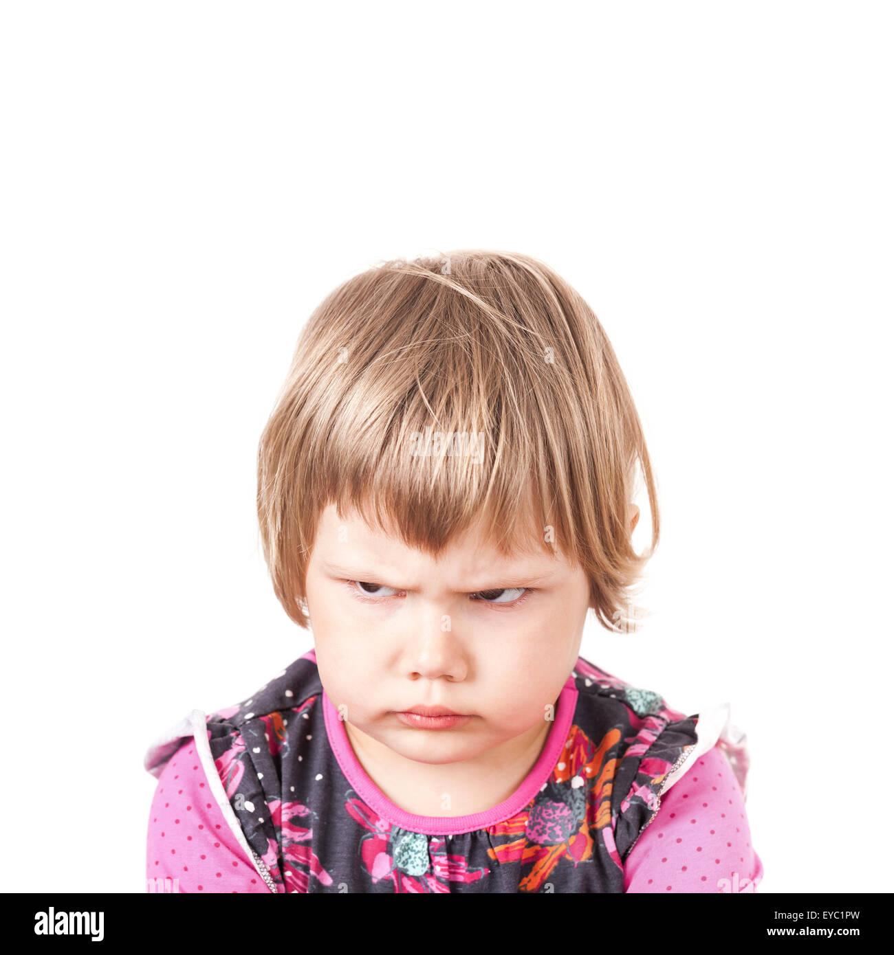 Cute Caucasian blond baby girl angry frowns, studio portrait isolated on white background Stock Photo