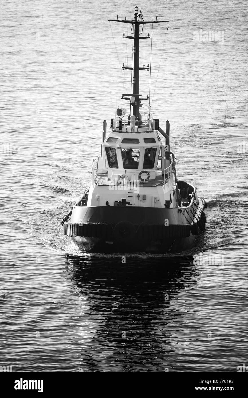 Tug boat underway, front view, black and white retro style Stock Photo
