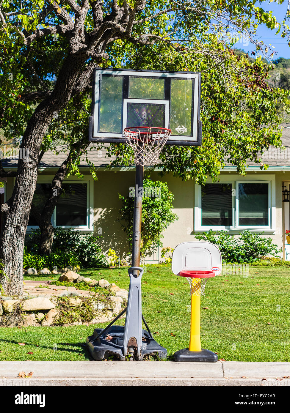 2 different sized basketball backboards one normal height and the other