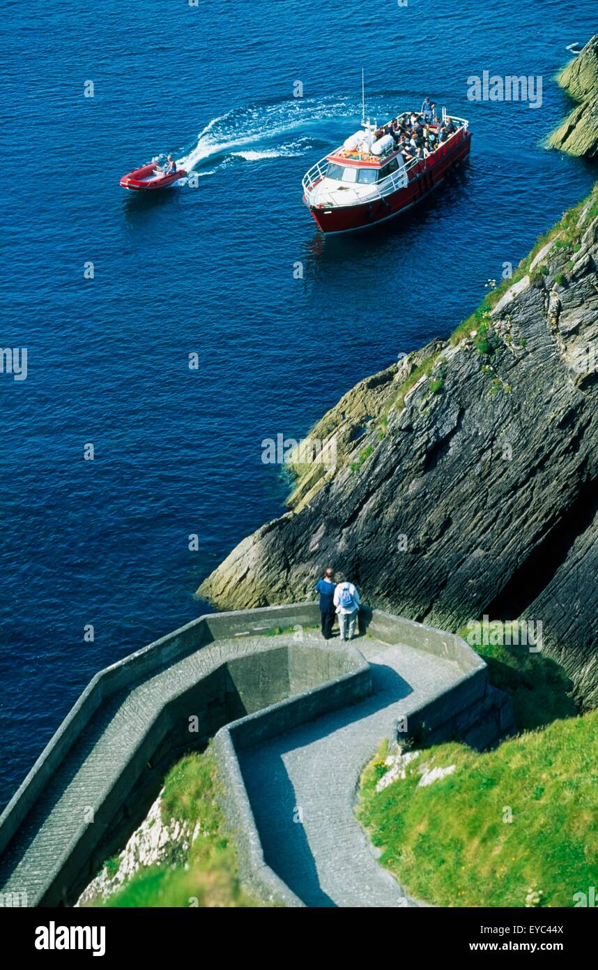Dunquin Harbour, Blasket Islands, Dingle Peninsula, Ireland; High Angle View Of Boats And People On A Path Stock Photo