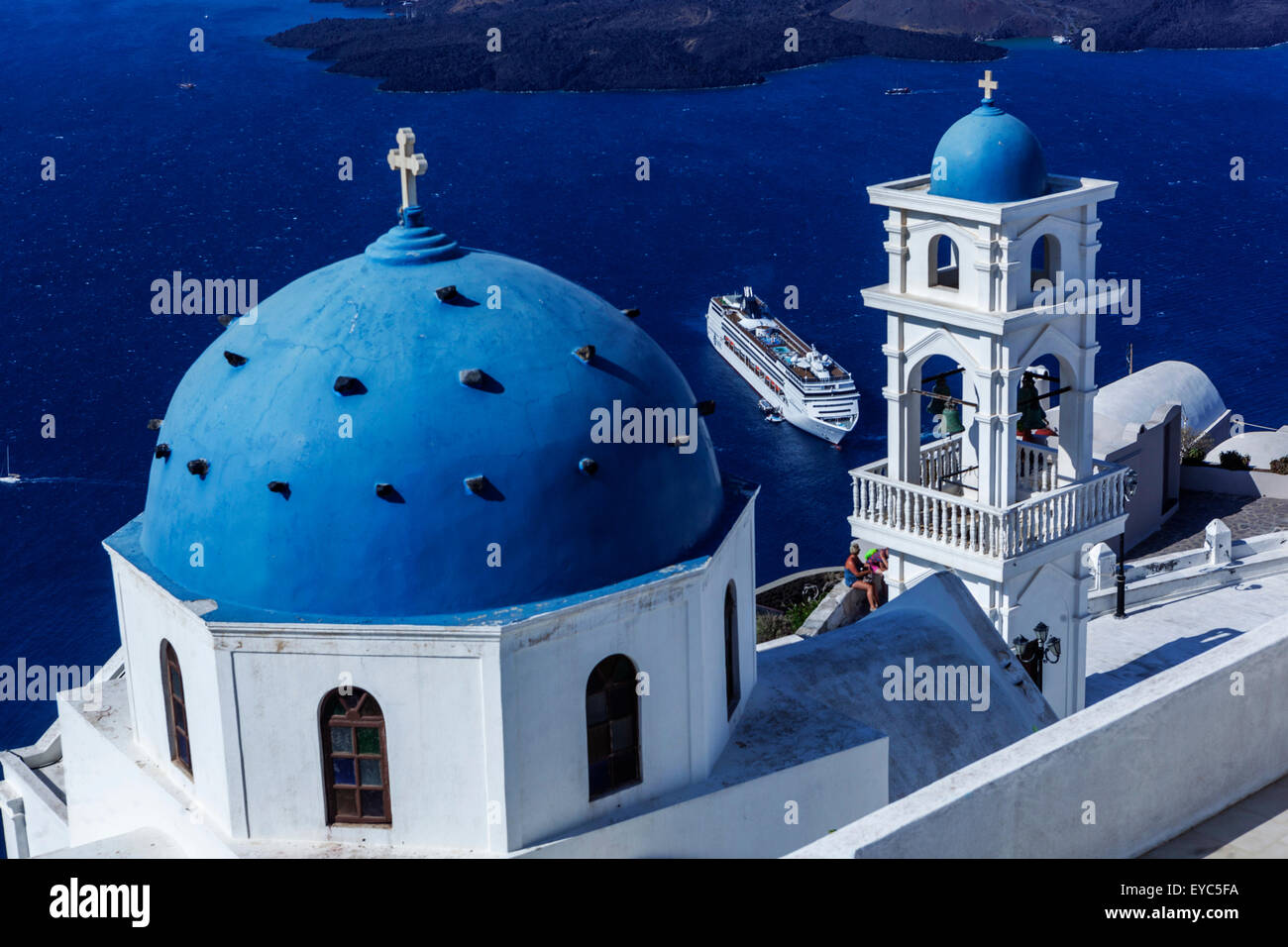 Anastasi Church at Imerovigli, Santorini blue dome on cliff Cyclades Greek Island Greece Islands moored cruise ship in caldera Sea Stock Photo