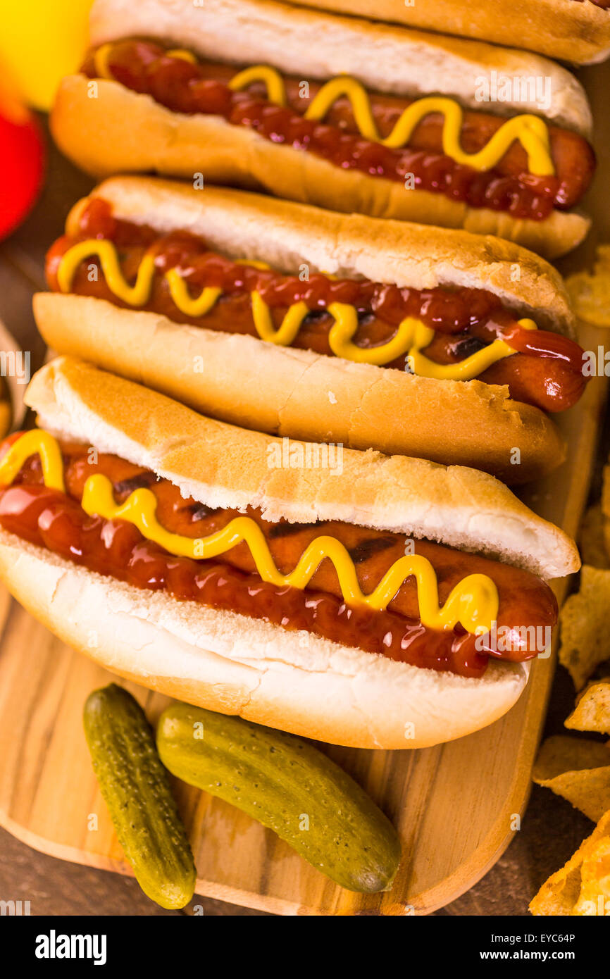 Grilled hot dogs on a white hot dog buns with mustard and ketchup Stock