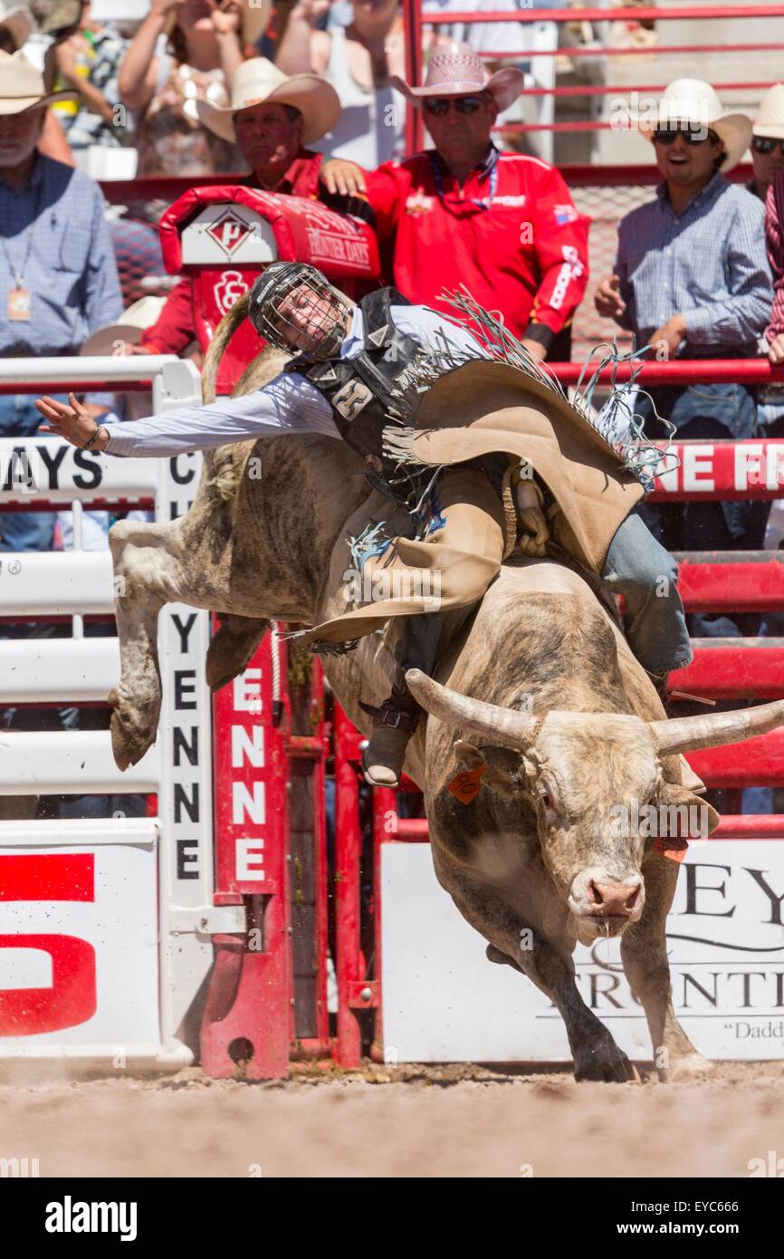 Cheyenne, Wyoming, USA. 26th July, 2015. Bull rider Jeff Bertus hangs on during the Bull Riding finals at the Cheyenne Frontier Days rodeo in Frontier Park Arena July 26, 2015 in Cheyenne, Wyoming. Frontier Days celebrates the cowboy traditions of the west with a rodeo, parade and fair. Stock Photo