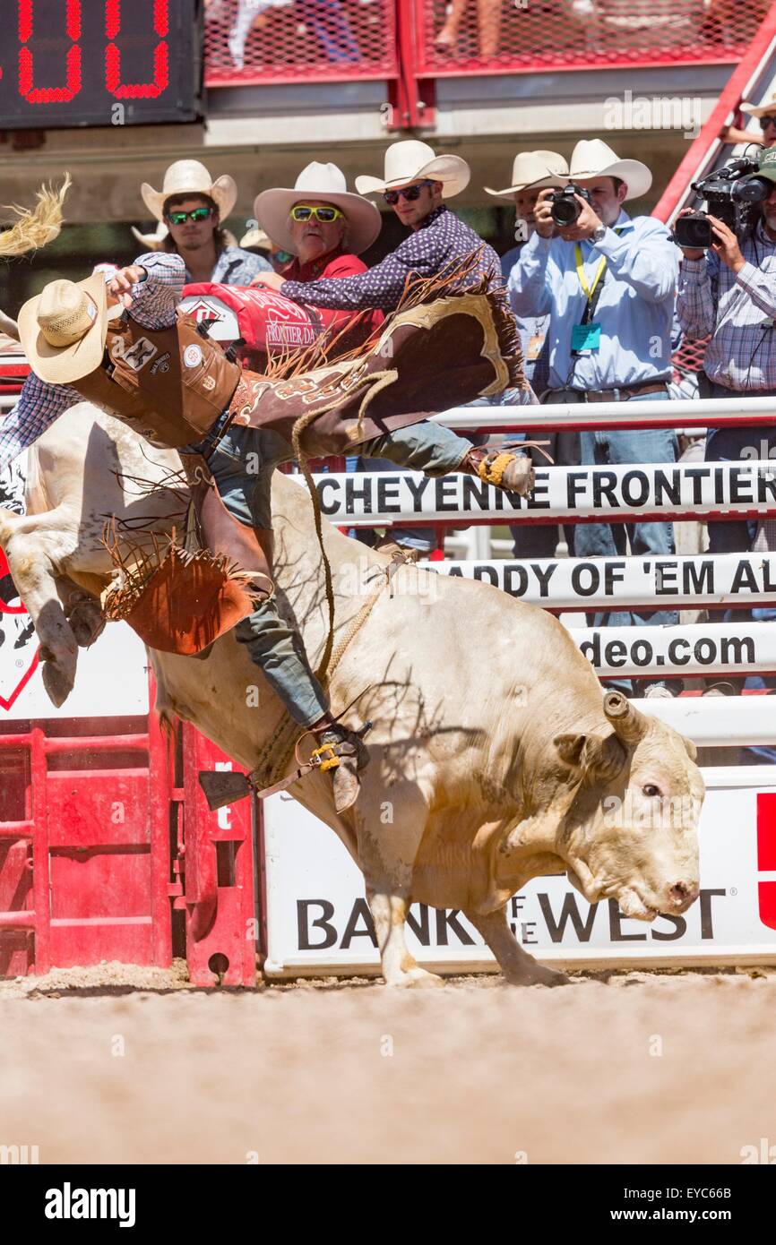 Cheyenne, Wyoming, USA. 26th July, 2015. Bull rider Caleb Sanderson is tossed from his ride during the Bull Riding finals at the Cheyenne Frontier Days rodeo in Frontier Park Arena July 26, 2015 in Cheyenne, Wyoming. Frontier Days celebrates the cowboy traditions of the west with a rodeo, parade and fair. Stock Photo
