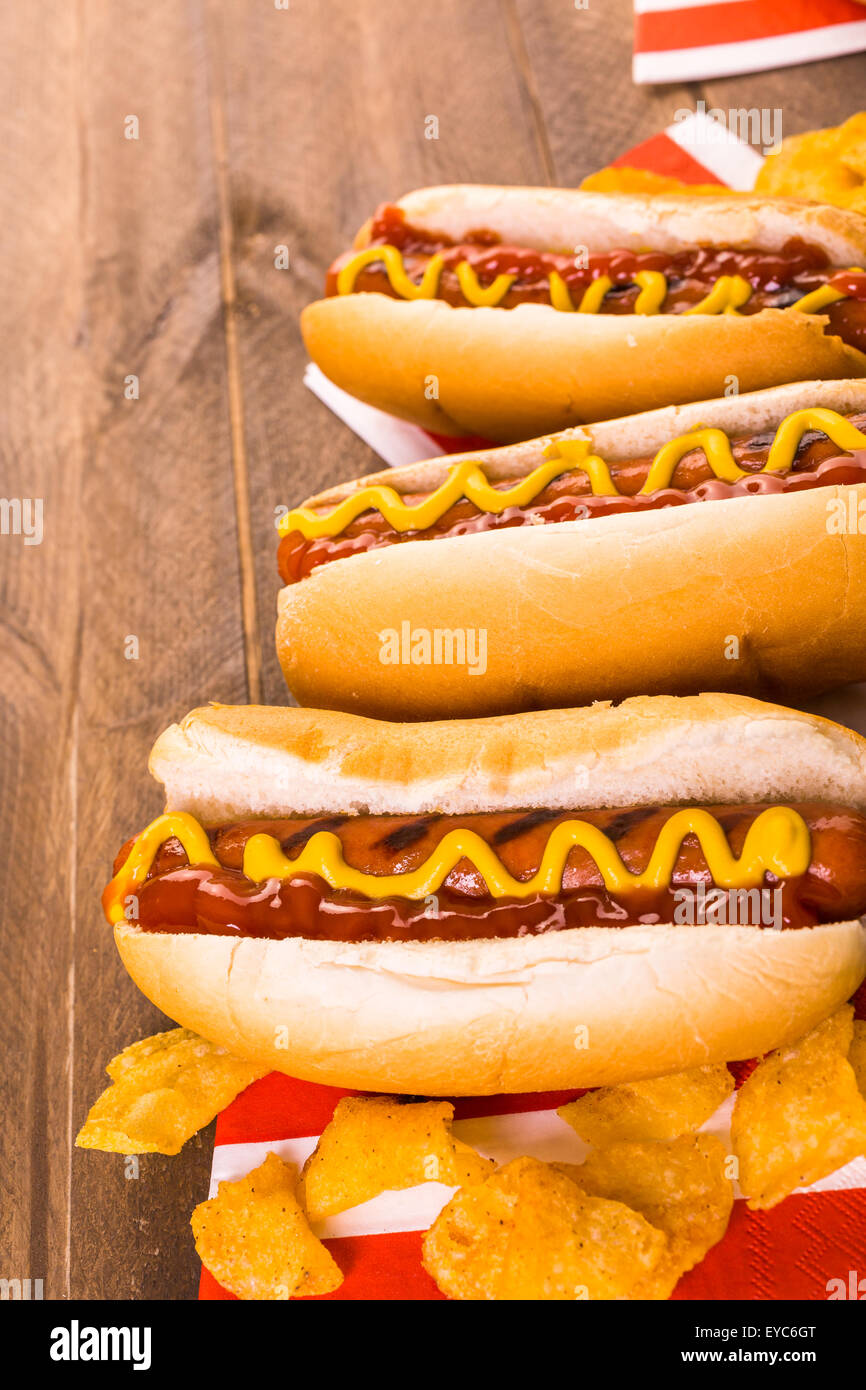 Grilled hot dogs on a white hot dog buns with mustard and ketchup Stock