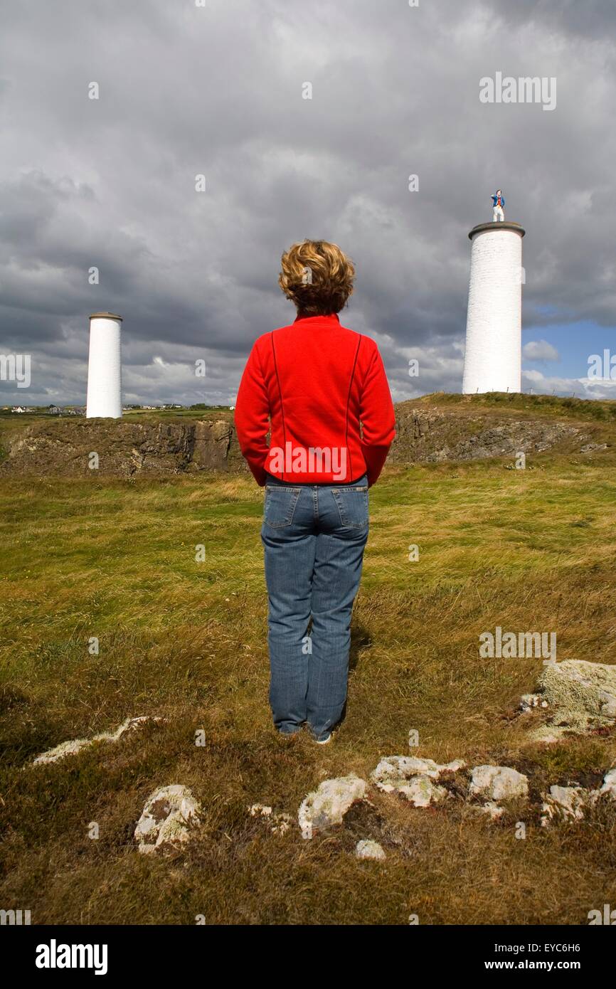 Tramore, County Waterford, Ireland; Woman Looking At Metal Man Beacons