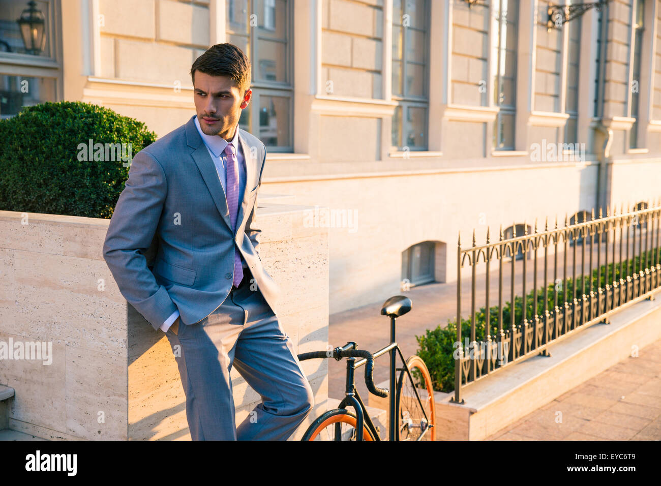 Handsome businessman standing outdoors in town Stock Photo - Alamy