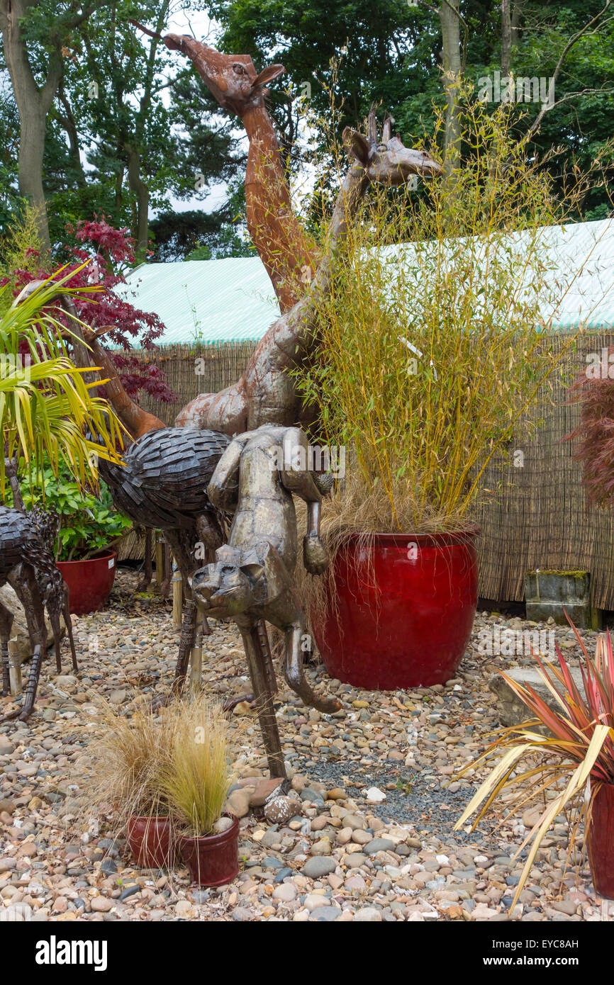 A collection of garden ornaments large size steel animals giraffes statues in a suburban garden centre Stock Photo