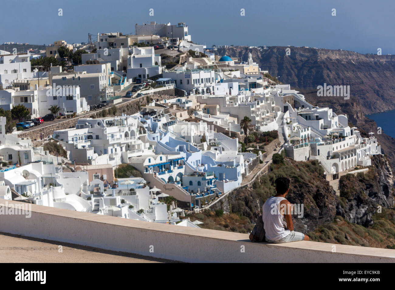 Tourist look at white buildings on cliff Firostefani, Santorini, Cyclades, Greek Island travel Santorini Greece architecture Stock Photo