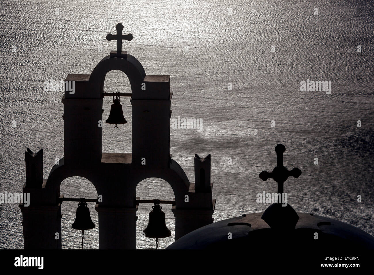 Greece Islands Santorini Greece Church architecture silhouette of a bell tower in the shadows Sea background, sunset church bells Stock Photo
