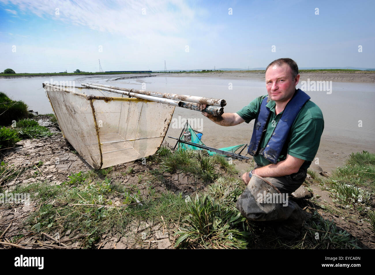 Environment Agency Bailiff Richard Dearnley with a confiscated oversized elver net and an illegal flow net (behind) on the banks Stock Photo