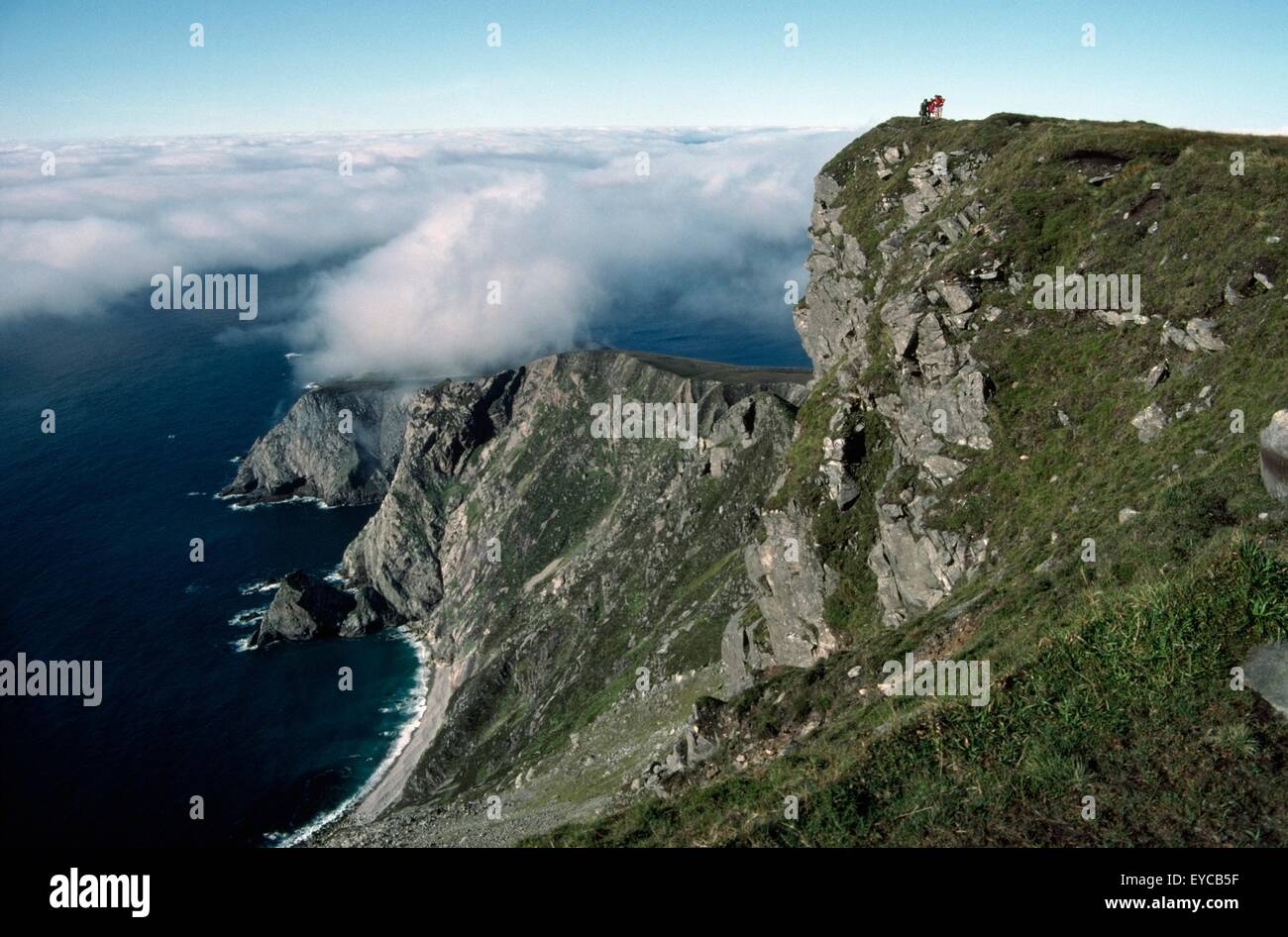 Croaghaun, Saddle Head, Achill Island, Co Mayo, Ireland; Hikers On The Cliff Of A Mountain Viewing Saddle Head Stock Photo