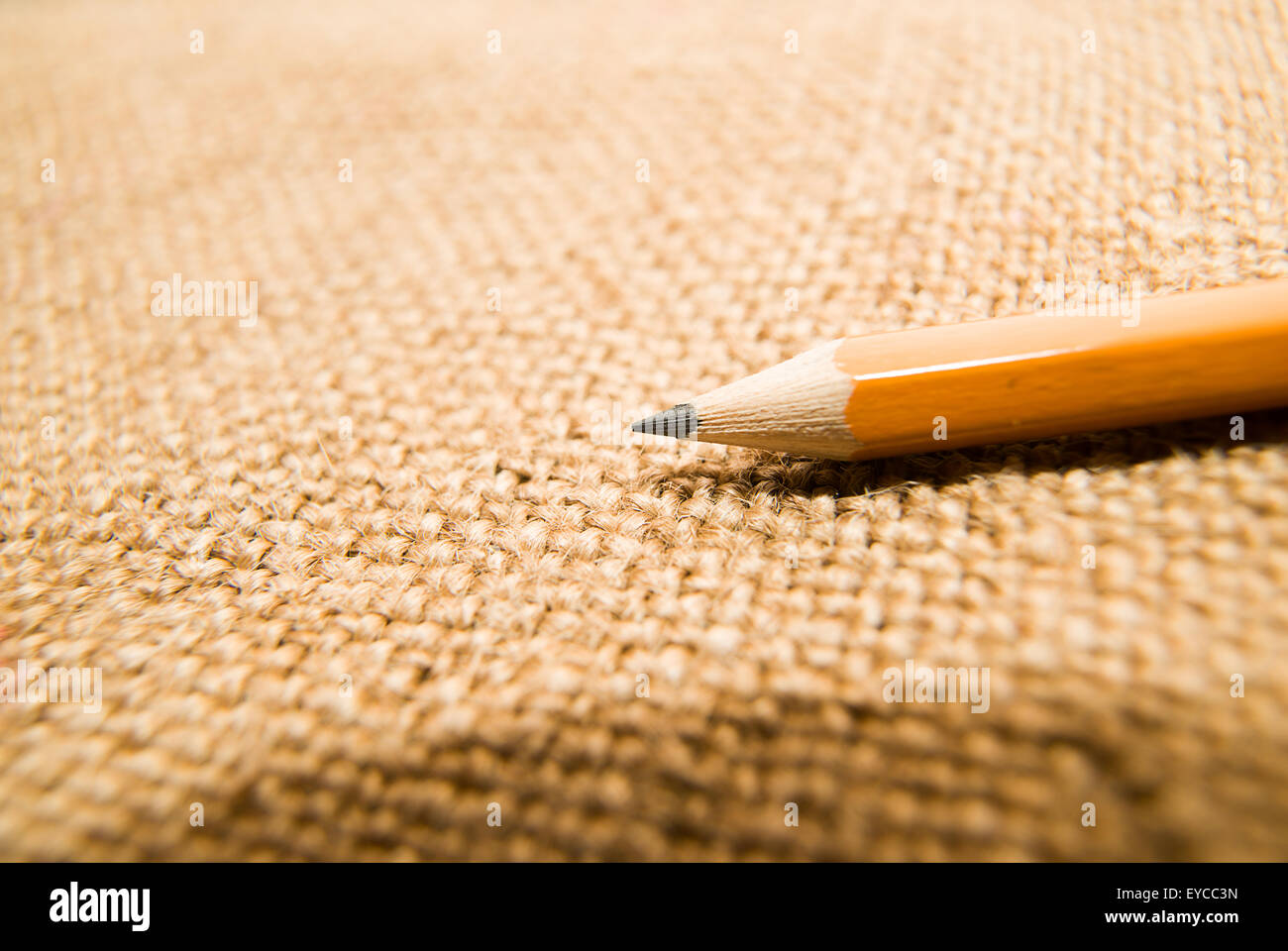 Yellow wooden pencil for drawing on old cloth Stock Photo - Alamy