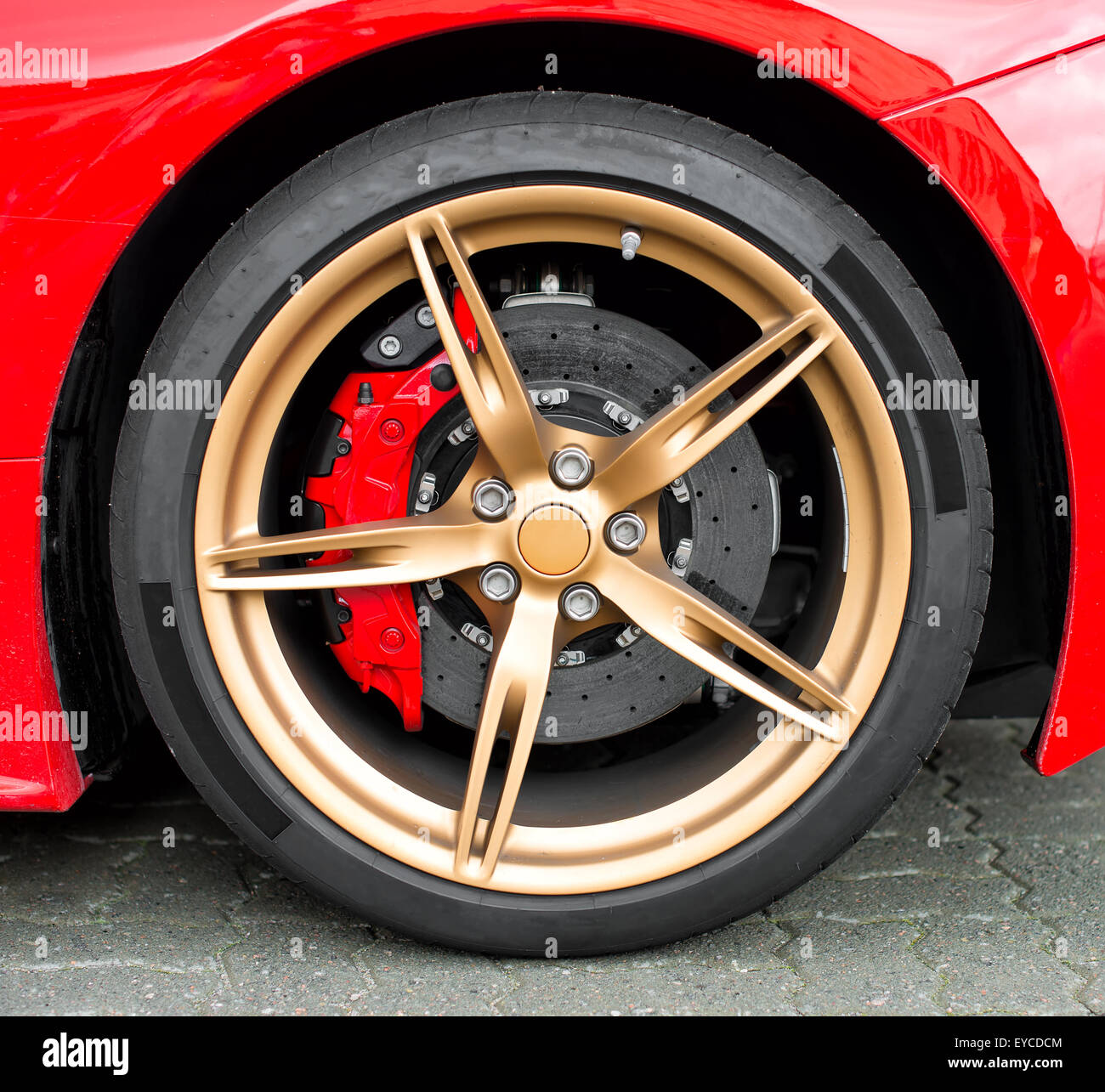 Red sports car wheel on the road Stock Photo - Alamy