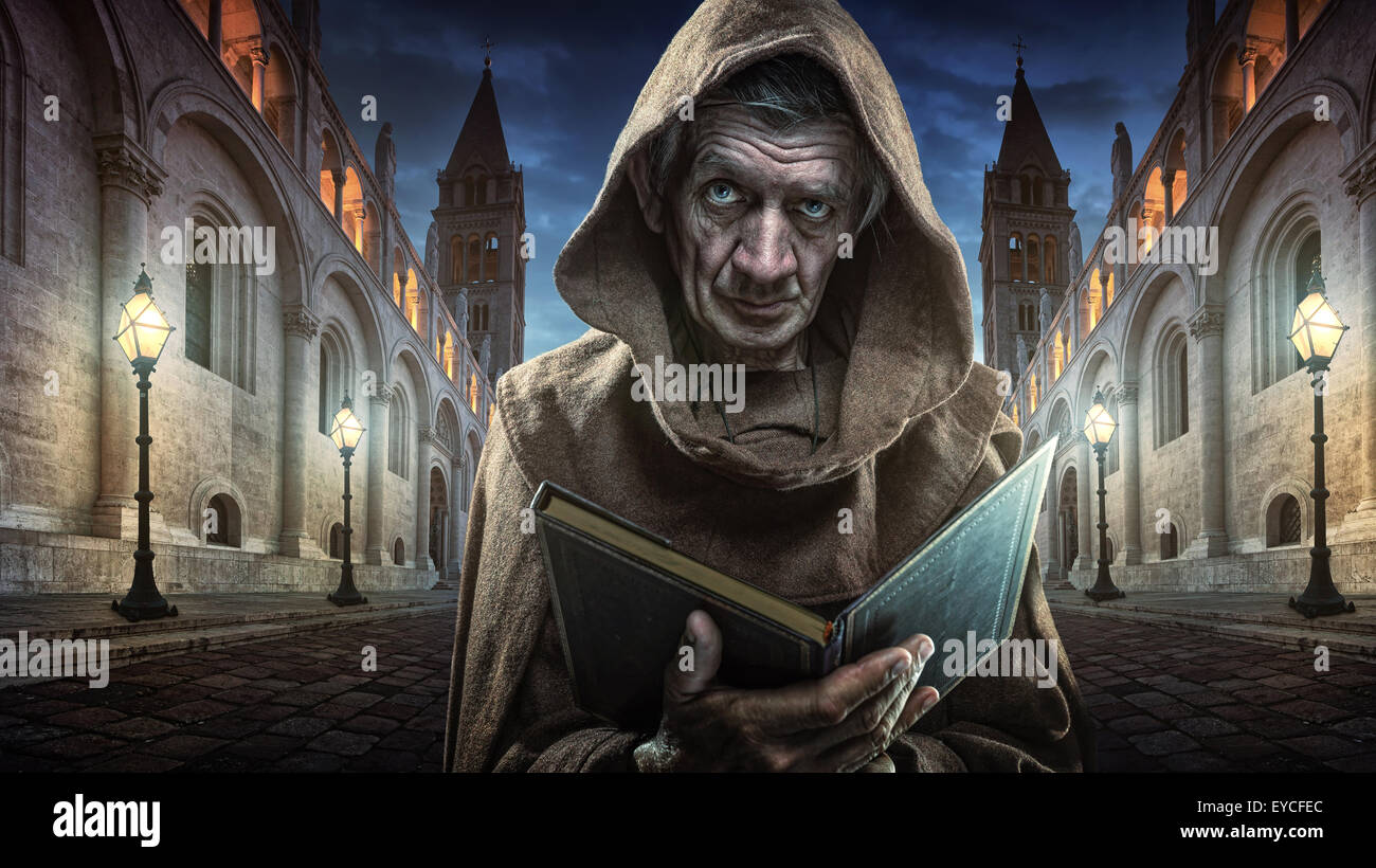 Monk priest front of the church holding the Bible Stock Photo Alamy