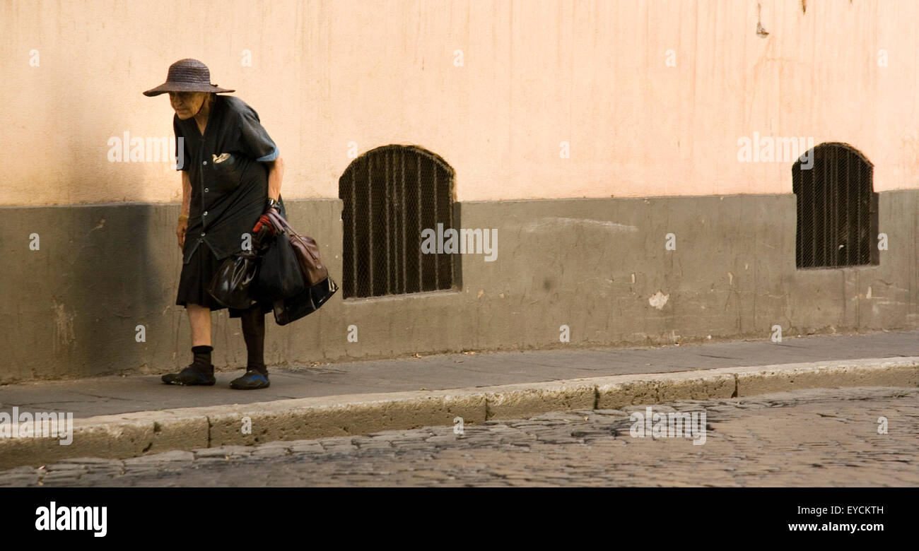 Rome, An old woman walks through the streets of Rome Stock Photo