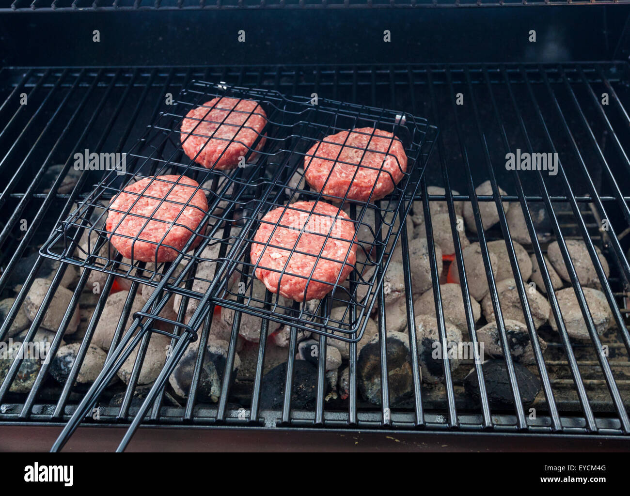 Charcoal BBQ. Burgers cooking on a barbecue Stock Photo