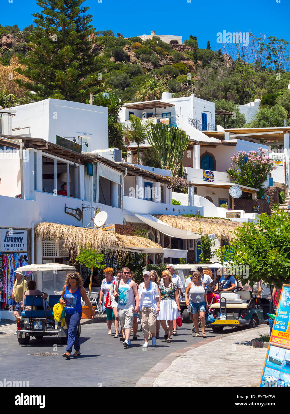 Sicily, Aeolian Islands, Panarea, group of tourists walking on the street Stock Photo