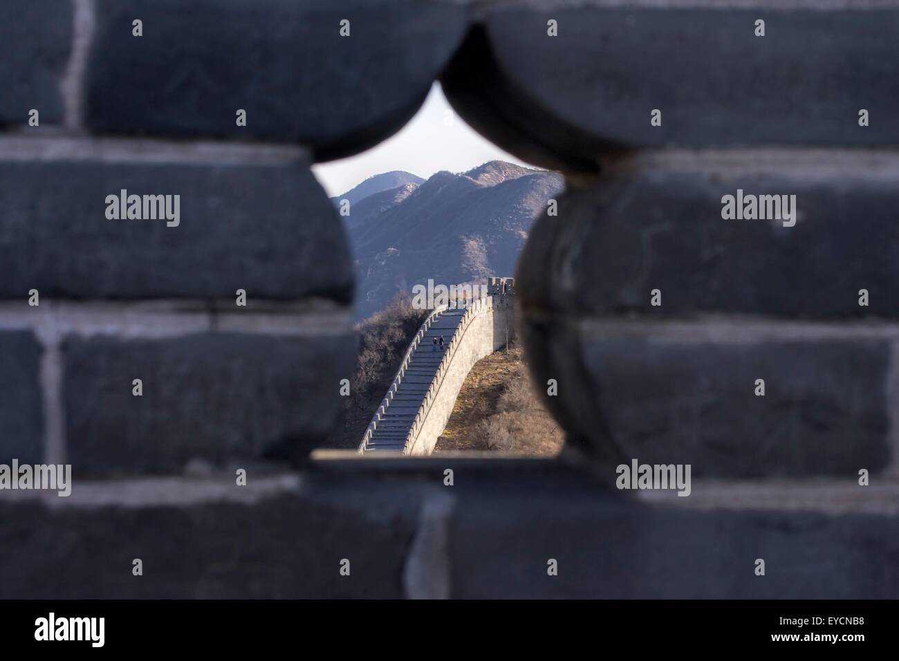 Peering through a parapet at the Great Wall of China in Badaling. Stock Photo