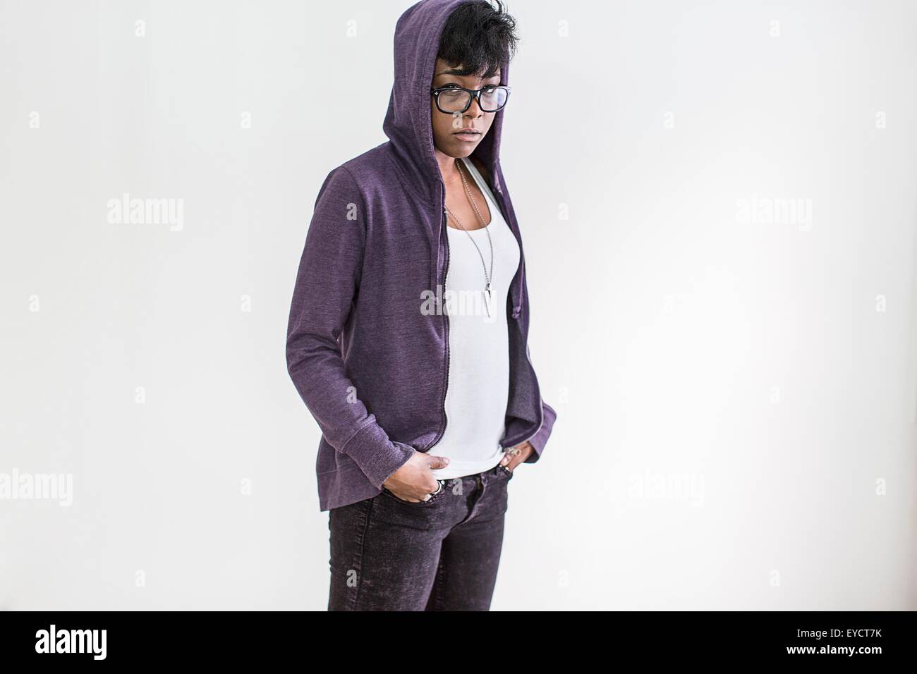 Studio portrait of young woman wearing hoody Stock Photo