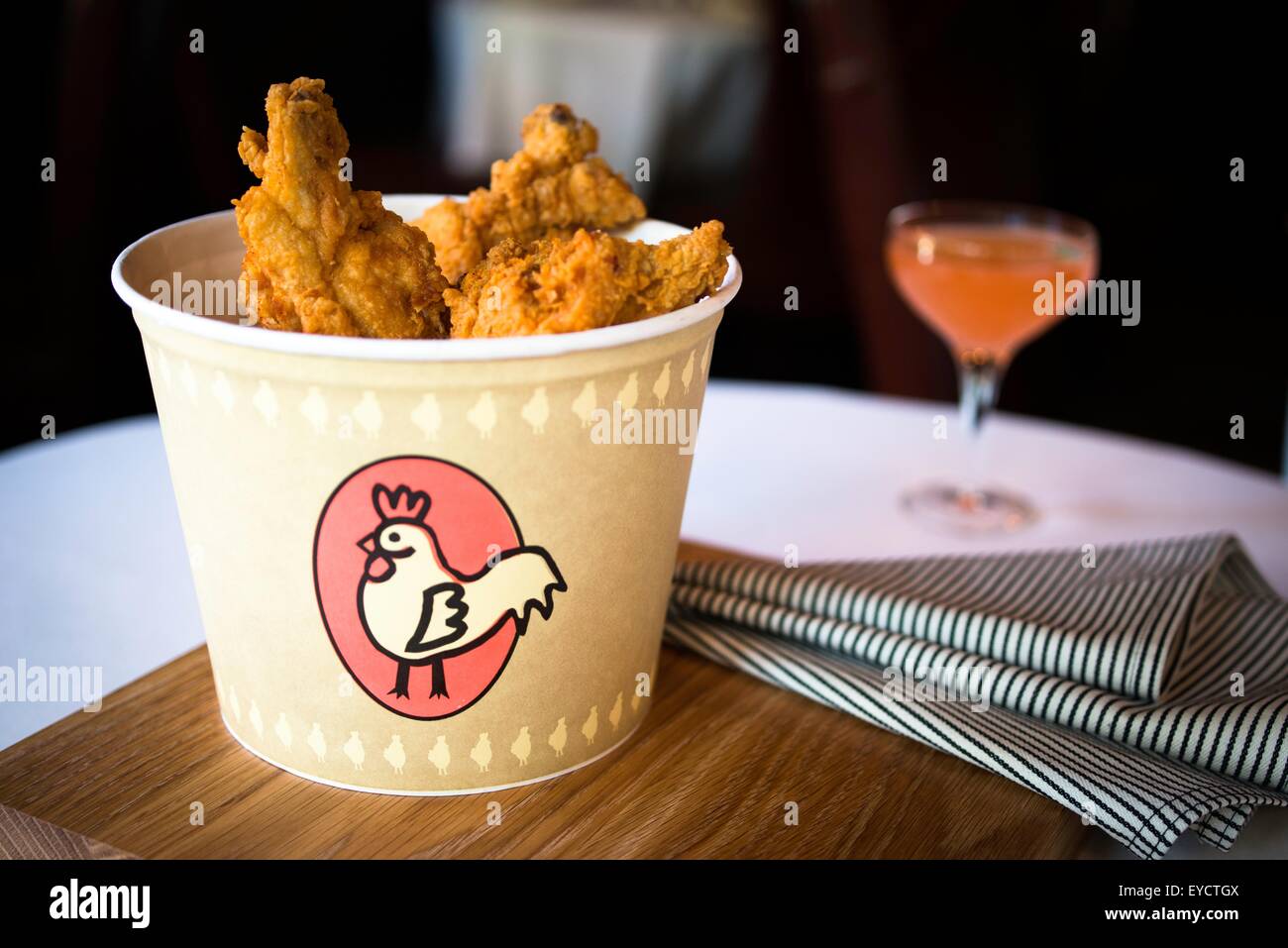 Bucket of fried chicken on restaurant table Stock Photo