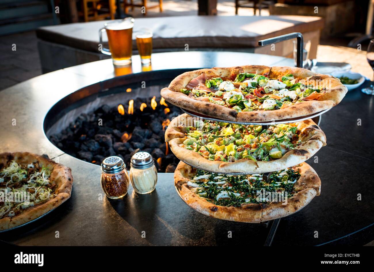 Fresh pizzas on stand by restaurant open fire Stock Photo