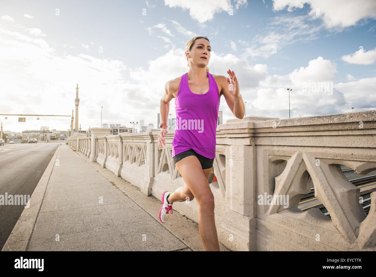 Young female runner running across bridge, Los Angeles, California, USA ...