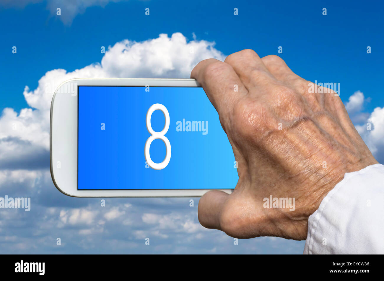Smart phone in old hand with number EIGHT on screen. Selective focus Stock Photo