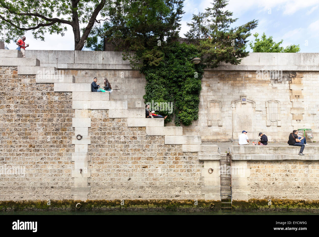 Parisians relax on the banks of the River Seine in Paris, France Stock Photo