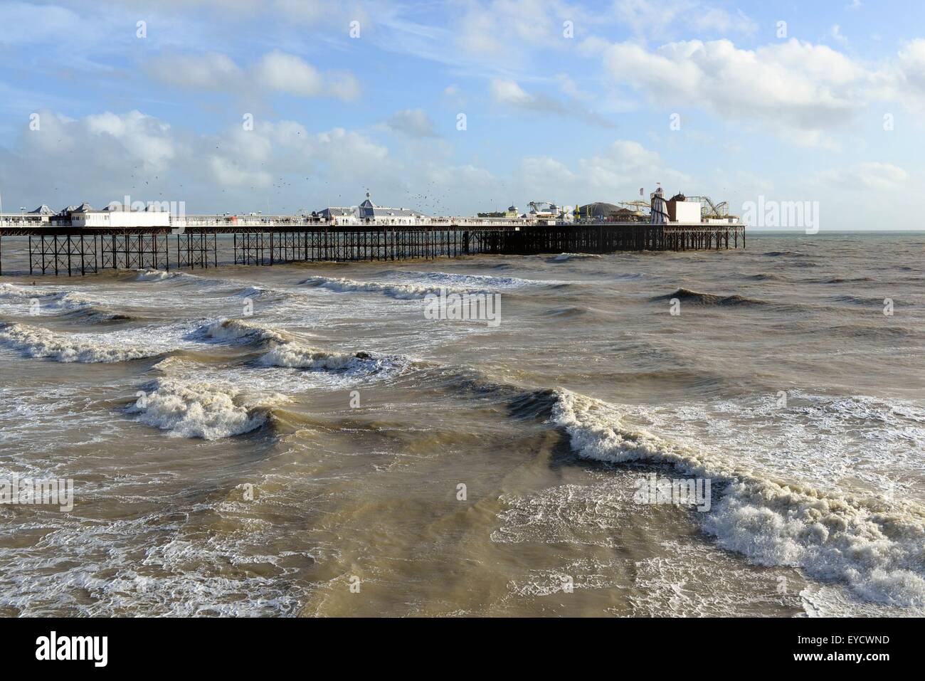 Brighton Pier and seafront with rolling waves on a stormy sea. Windy October day, East Sussex, UK Stock Photo