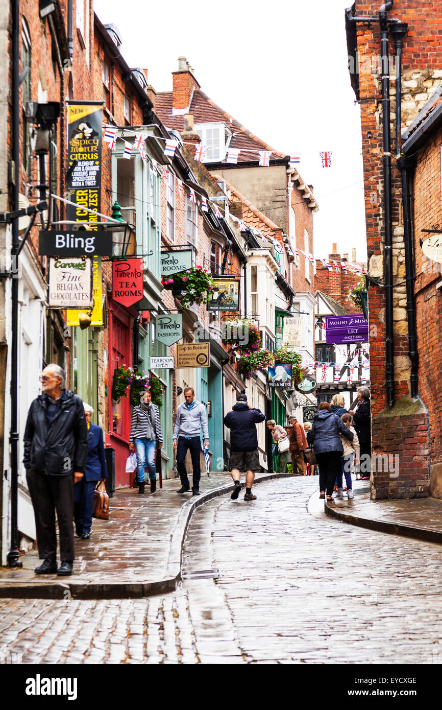 Steep Hill shops shopping Lincoln city UK shop signs dominate scene