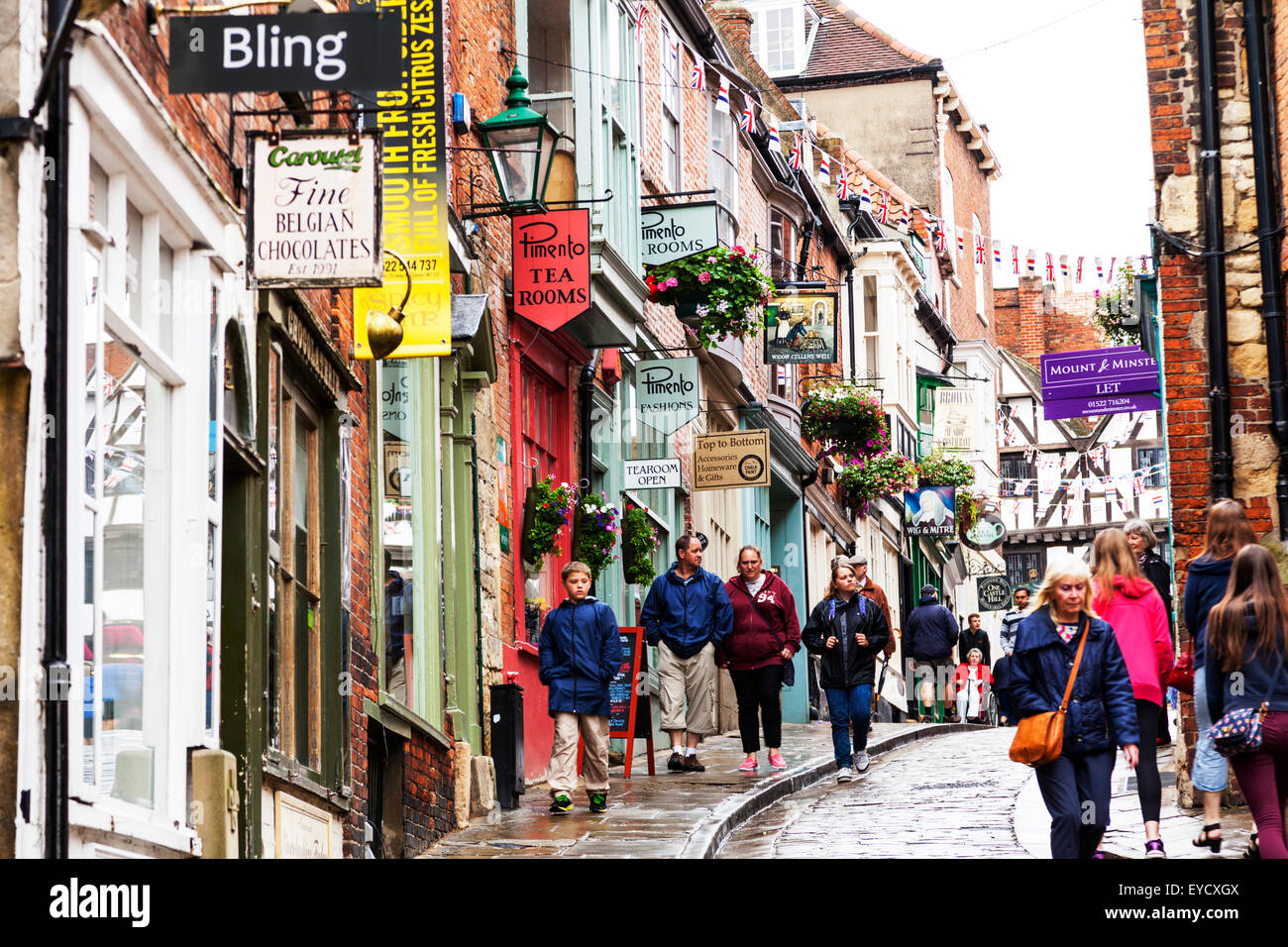 Steep Hill shops shopping Lincoln city UK shop signs dominate scene
