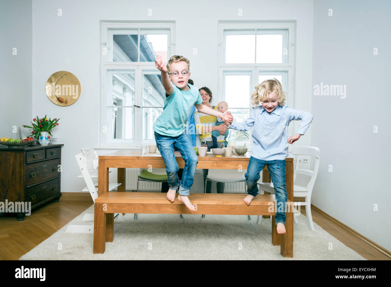 Family with three children in living room Stock Photo