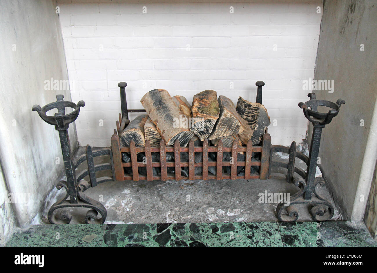 A Vintage Fireplace With Wooden Logs In The Grate Stock Photo