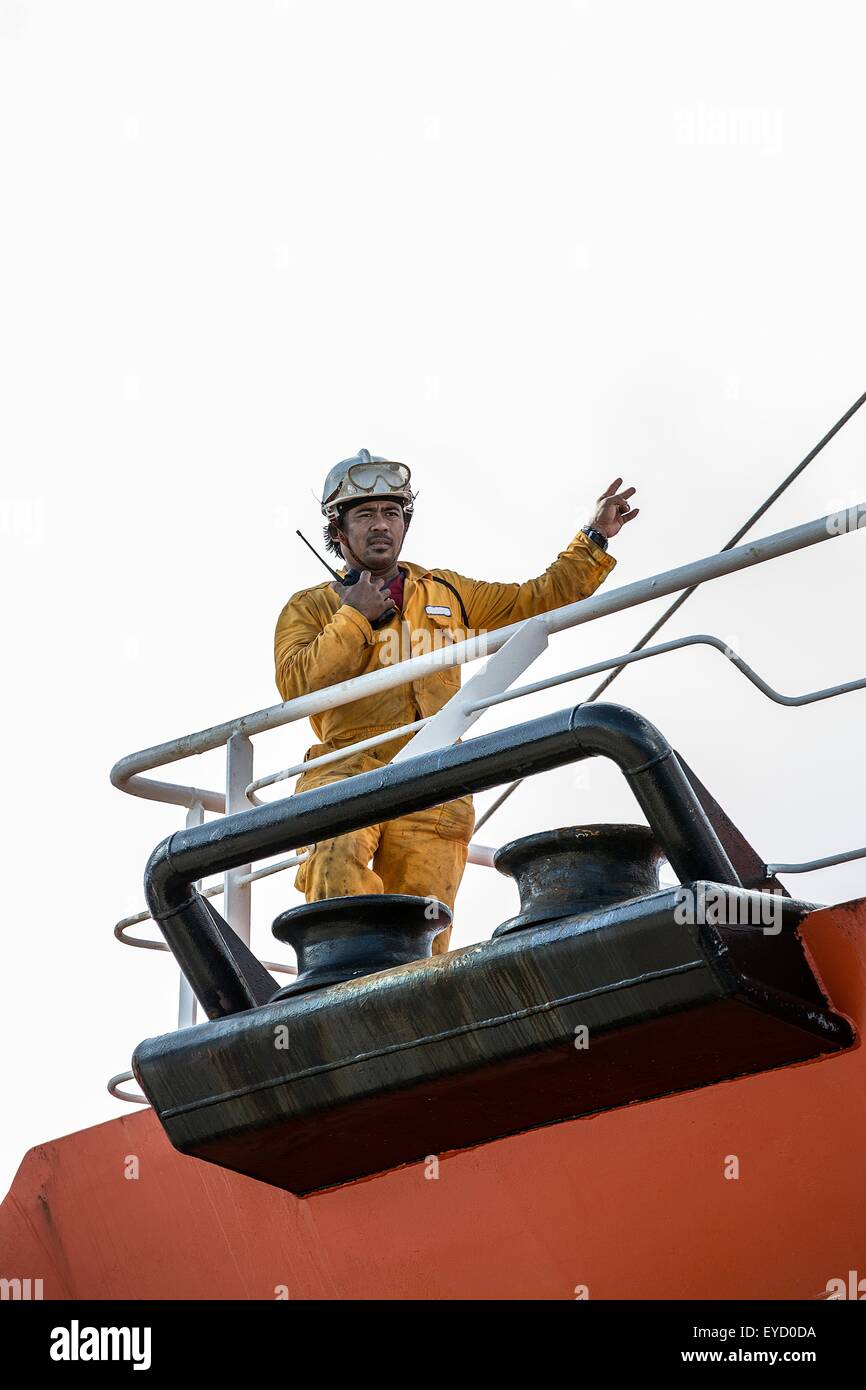 Worker using walkie talkie on oil tanker deck Stock Photo