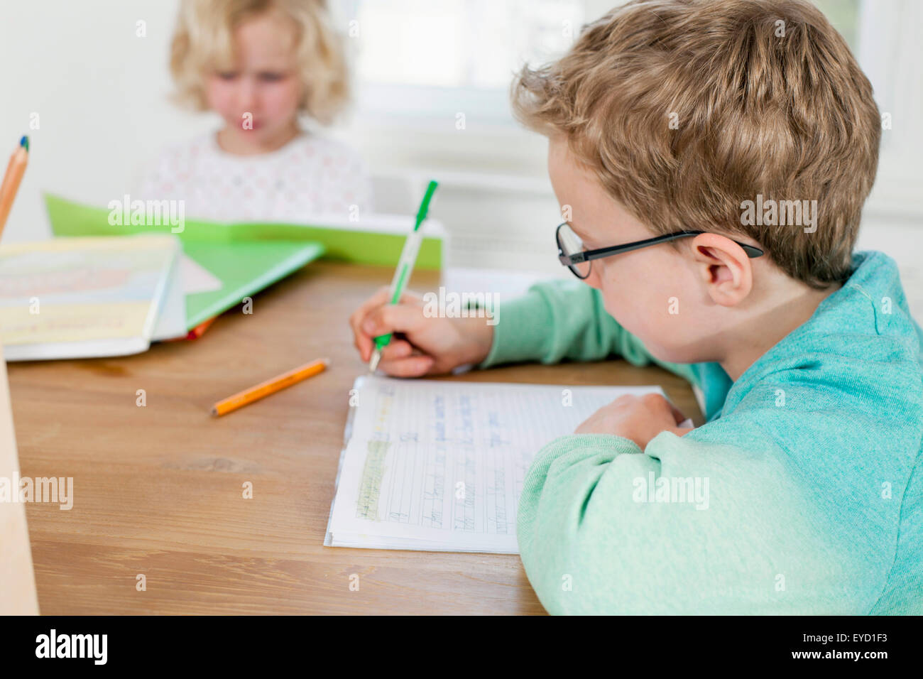 Boy and girl writing and reading Stock Photo